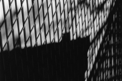 black and white image of a chain link fence from the side.