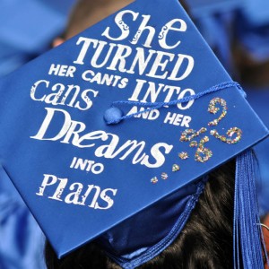 Graduation cap with letters pasted on that make the phrase "She turned her cants into cans and dreams into plans"